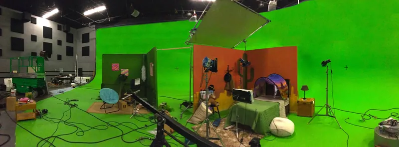 Grip rigging overhead lighting on the studio truss