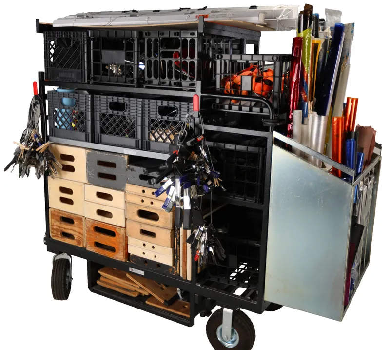 Studio taco cart loaded with apple boxes, clamps, tape, and expendables